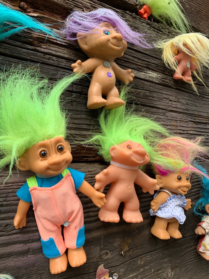 Troll toys displayed on railroad trestle