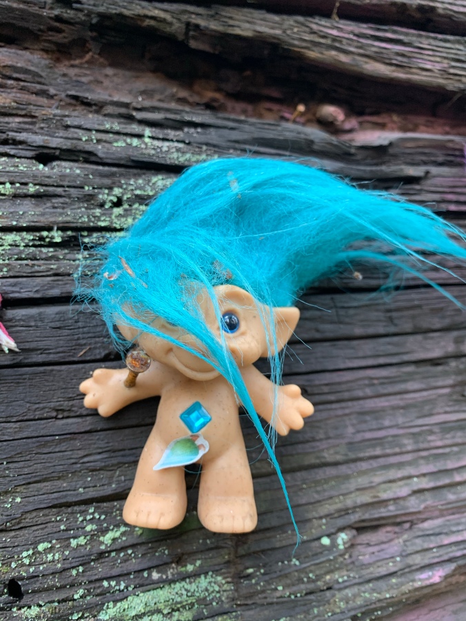Troll doll with blue hair and blue belly jewel